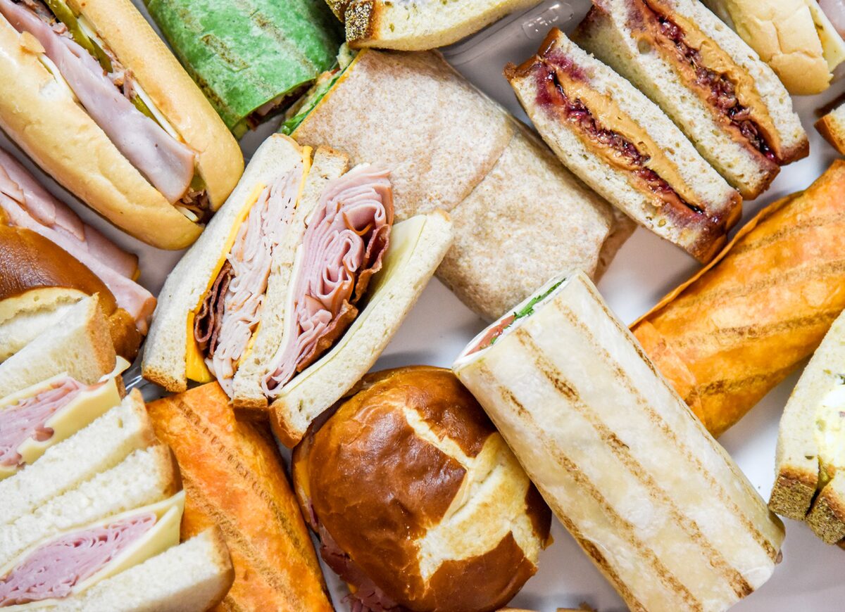 An overhead spread of fresh grab-and-go sandwiches, wraps and pretzel rolls.